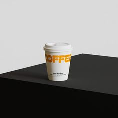 a coffee cup sitting on top of a black table