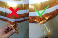 two balloons that have been wrapped in gold foil and are being held by someone's hand