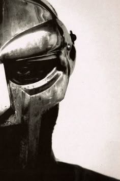 a black and white photo of a man wearing a helmet