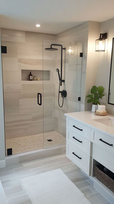 a bathroom with a walk in shower next to a white sink and counter top under a mirror