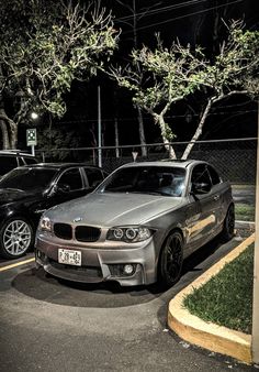 two cars parked next to each other in a parking lot