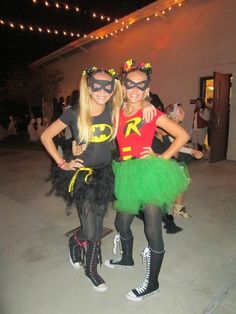 two women dressed up as batman and robinette for the halloween costume contest in front of a building