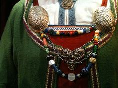 a close up of a person wearing a costume with beads and necklaces on it