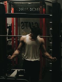 a man standing in front of a gym machine