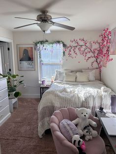 a bedroom with a bed, desk and two teddy bears on the chair in front of it