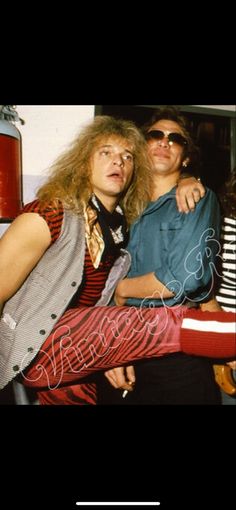 two men are standing next to each other