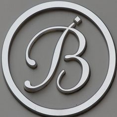 the letter b is inscribed in silver on a gray background