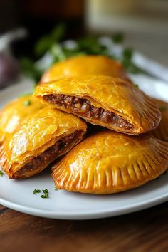 three pastries on a white plate with parsley