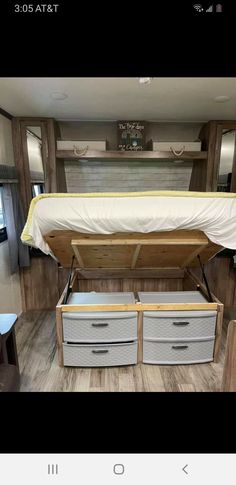 the inside of a camper with drawers and a bed