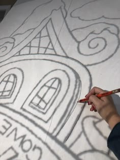 someone is drawing on the side of a building