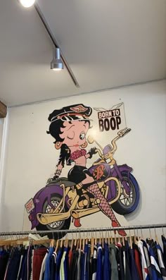 there is a woman on a motorcycle painted on the wall in this store's shop