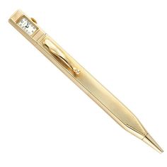 a gold pen with a clock on it