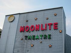 a large sign on the side of a building that says moonlite theatre with stars