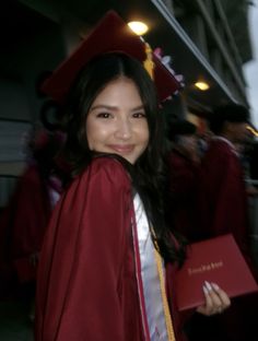 a woman in a graduation gown and cap