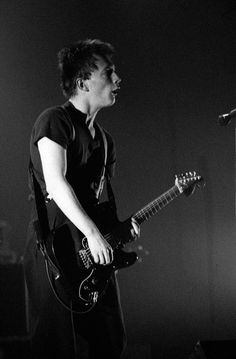 black and white photograph of a man playing guitar