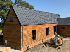 a small wooden house with a metal roof