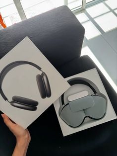 a pair of headphones sitting on top of a table next to a box with an earphone in it