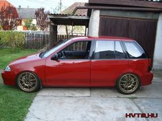 a red car parked in front of a house