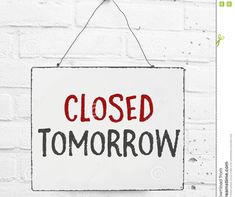 a closed sign hanging on a brick wall with the word'closed tomorrow'painted on it