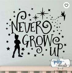 a wall decal with the words never grow up in black and stars on it
