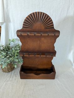 a wooden box with a plant in it next to a white towel on a table