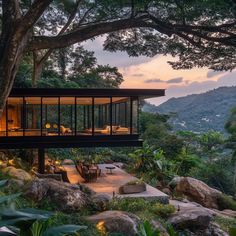 the house is surrounded by trees and rocks