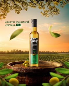 a bottle of olive oil sitting on top of a barrel