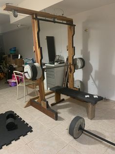 a gym equipment set up in the middle of a room with other items on the floor