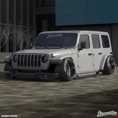 a white jeep parked in front of a building
