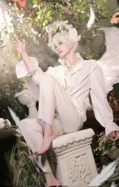 a woman with white hair sitting on top of a statue