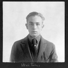 an old black and white photo of a man in a suit with a serious look on his face