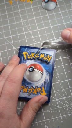 someone is cutting out a pokemon card with scissors