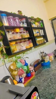 a kitchen counter with many jars and containers on it