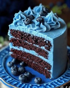 a slice of blue cake with chocolate frosting on a plate