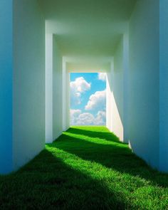 an empty hallway with grass and blue sky in the background