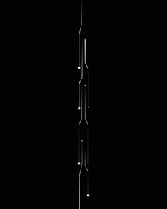 a black and white photo of a clock tower in the dark with lights coming from it