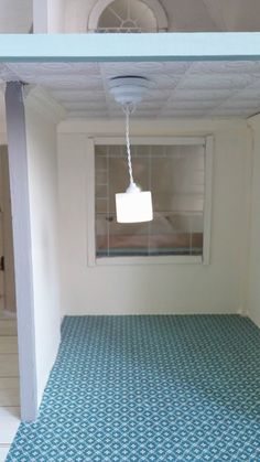 an empty room with blue and white tiles on the floor