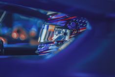 the reflection of a person in a car's side view mirror with an american flag on it