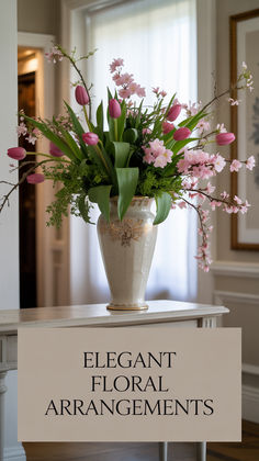 a vase filled with pink flowers sitting on top of a table next to a sign