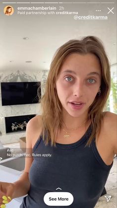 a woman holding a banana in her hand and looking at the camera with an expression on her face