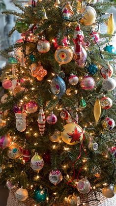 a small christmas tree with ornaments on it