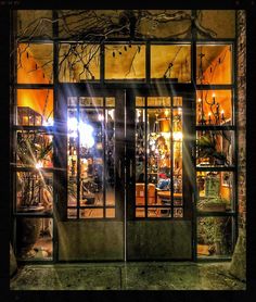a store front with the lights on and windows lit up