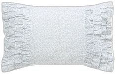 a white pillow with ruffles on the front and back of it, against a white background