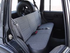 the interior of a car with grey seats