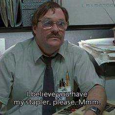 a man sitting at a desk with papers and a calculator