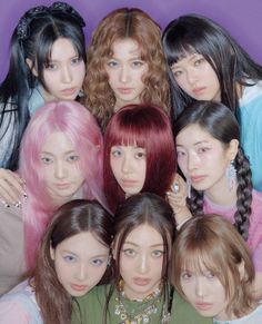 a group of young women standing next to each other in front of a purple wall