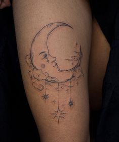a woman's thigh with a crescent and stars tattoo on it