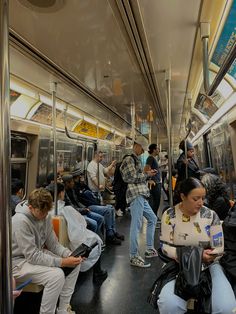 many people are sitting on the subway train