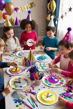 a group of children sitting around a table with paper plates and confetti on it