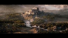 an aerial view of a castle in the middle of a forest with fog coming from it